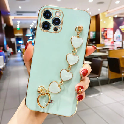 Funda con cadena y pulsera con forma de corazón chapado a la moda para iPhone 14, 15, 16 Pro Max Plus, funda a prueba de golpes