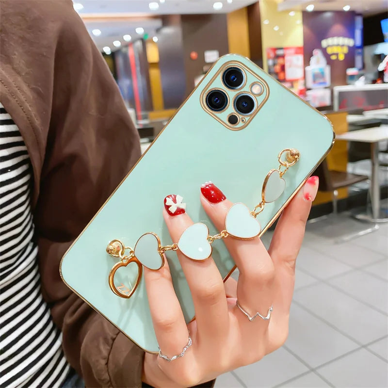 Funda con cadena y pulsera con forma de corazón chapado a la moda para iPhone 14, 15, 16 Pro Max Plus, funda a prueba de golpes